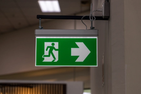 green-emergency-exit-sign-showing-the-way-to-escap-2023-04-25-18-50-37-utc